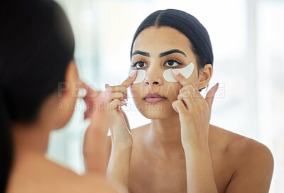 Buy stock photo Woman, mirror and skincare with eye patch in bathroom for antiaging, beauty and glow with self care. Female person, towel and home or apartment with treatment for dark circles, facial and grooming