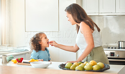 Buy stock photo Mother, child and feeding with smile, help and guidance for cooking and support in kitchen. Woman, girl and learning to cut vegetables for dinner, meal and healthy salad diet with fun bonding at home