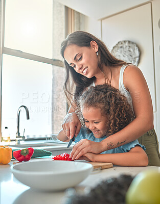 Buy stock photo Mother, child and teaching to cook with smile, help and guidance for support in kitchen. Woman, girl and learning to cut vegetables for dinner, meal and healthy salad diet with fun bonding at home