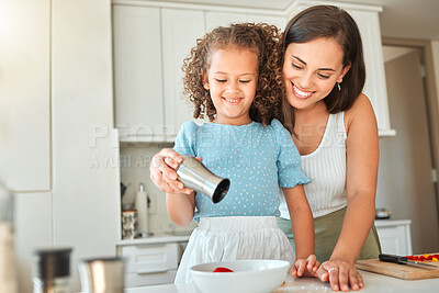 Buy stock photo Mother, girl and teaching with salt, smile and guidance for cooking and seasoning in kitchen. Woman, child and learning with vegetables for dinner, meal and healthy diet with fun bonding at home