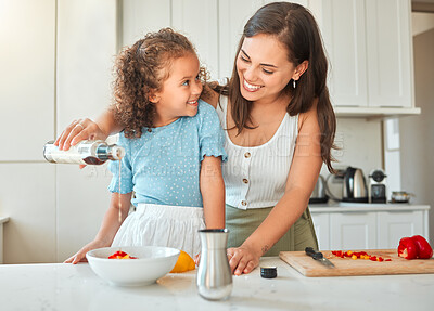 Buy stock photo Woman, girl and teaching with salad dressing, smile and guidance for cooking and seasoning in kitchen. Mother, child and learning with vegetables for dinner, meal and healthy diet with fun at home