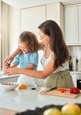 Buy stock photo Mother, girl and cooking with smile, pepper grinder and guidance for teaching and seasoning in kitchen. Woman, child and learning with vegetables for dinner, meal and healthy diet with fun at home