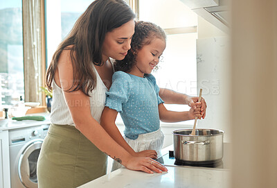 Buy stock photo Mother, child and learning cooking with pot, smile and guidance for support in kitchen. Woman, girl and teaching stove safety for dinner, meal and healthy diet preparation with fun bonding at home