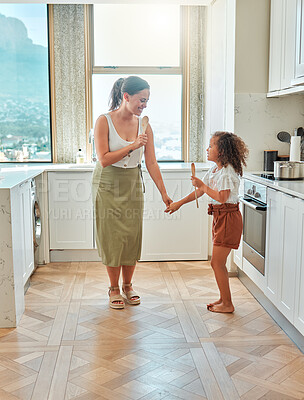 Buy stock photo Fun, singing and mom with daughter, kitchen and bonding of family, child and parent in home and smile. Happy, woman and girl with spoon, playful and goofy with youth, mother and break in weekend