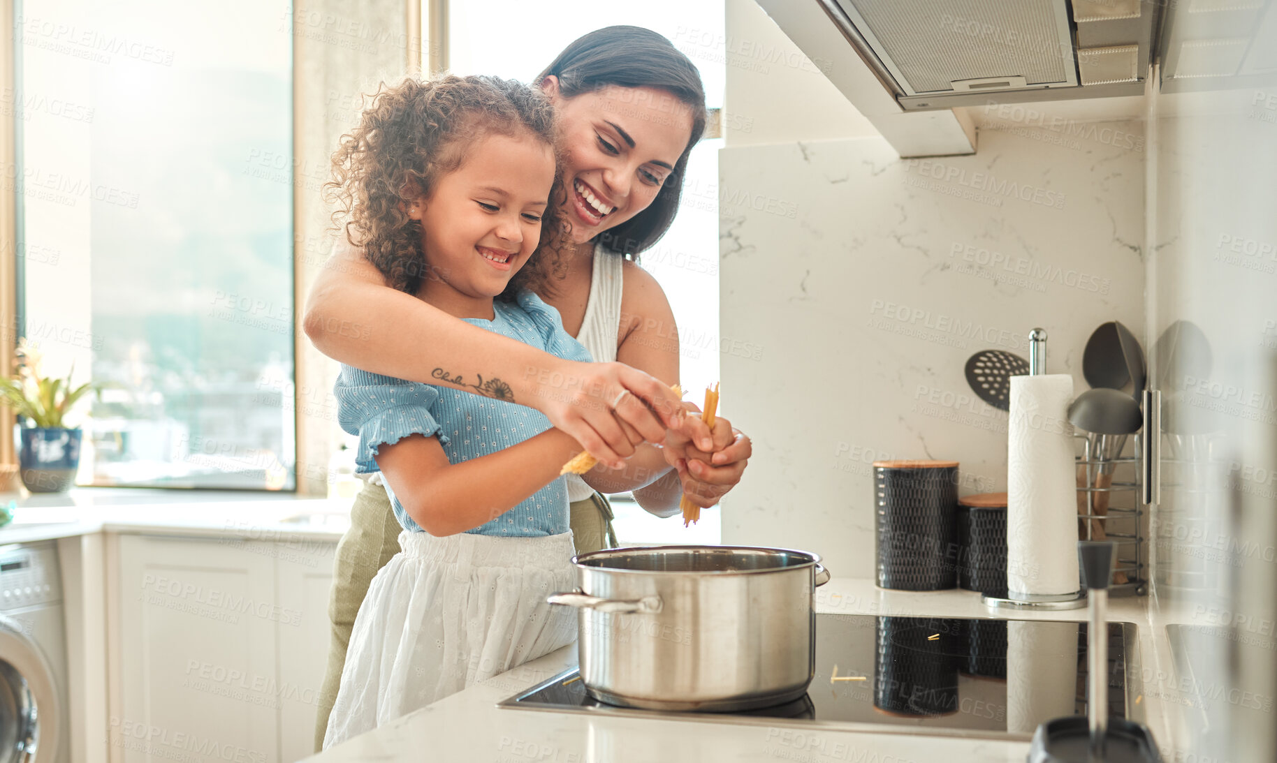 Buy stock photo Woman, girl and learning cooking with spaghetti, smile and guidance for support in kitchen. Mother, child and teaching stove for pasta dinner, meal and healthy diet preparation with bonding at home