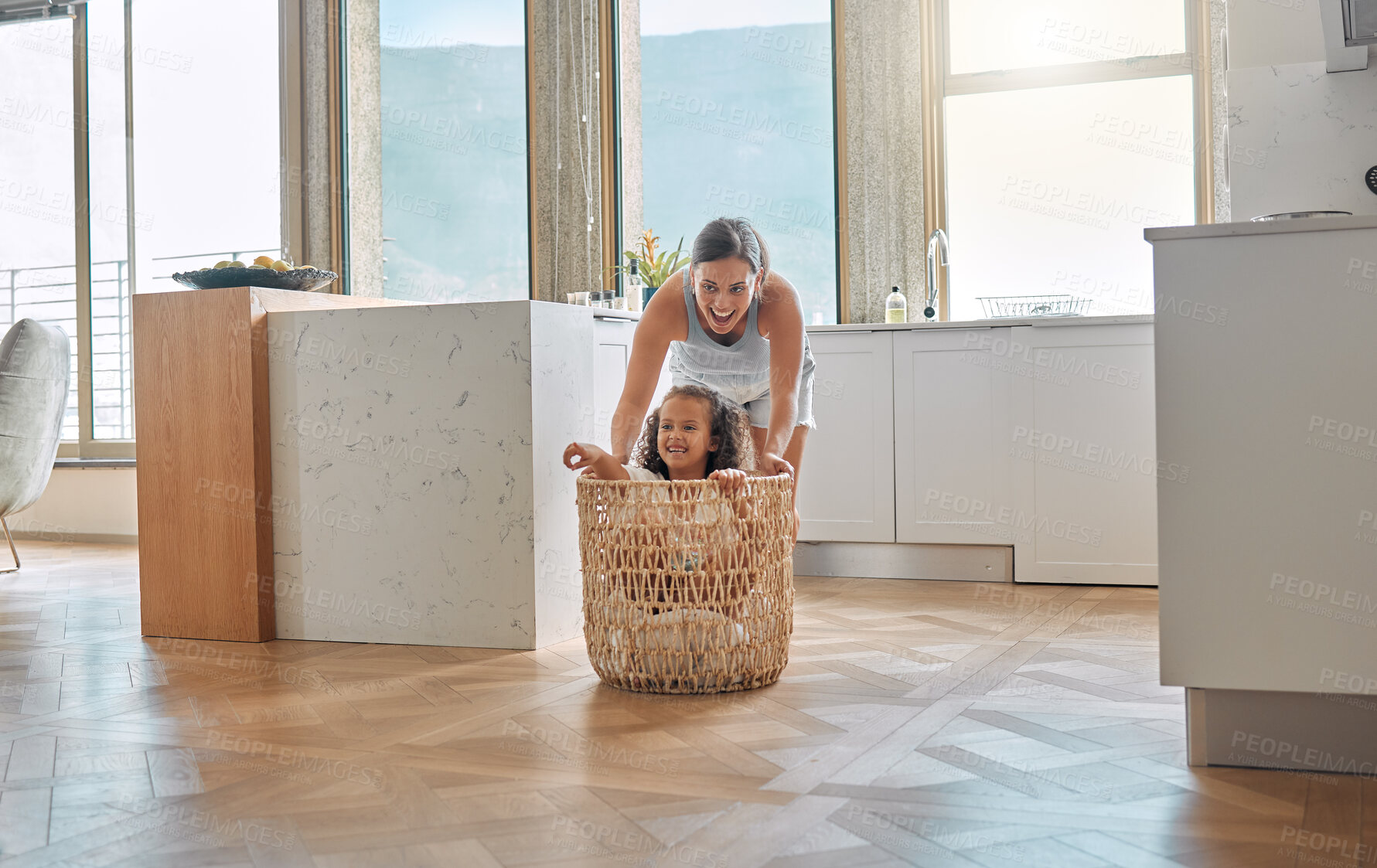 Buy stock photo Playful, laundry and basket with mother and daughter in house for support, cleaning and helping. Happiness, fun and housekeeping chores with woman and child in family home for linen, crazy and love