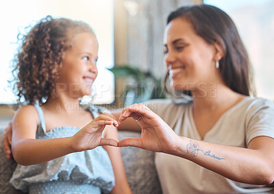 Buy stock photo Mother, hands and heart in home with girl for bonding, support and connection on sofa on weekend. Happy family, sign and love on couch with mom and daughter for care, relax and relationship together