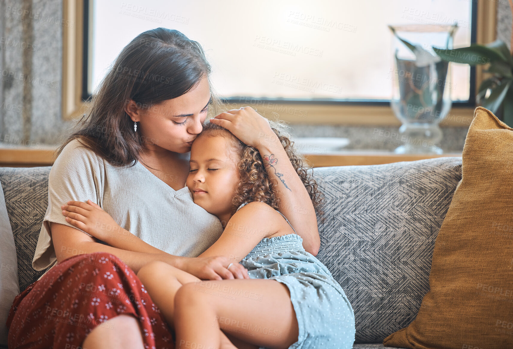 Buy stock photo Mother, kiss and hug child in home, love and holding sleeping girl with dream in living room. Mama, daughter and embrace for security in relationship, weekend nap and support kid for care on couch