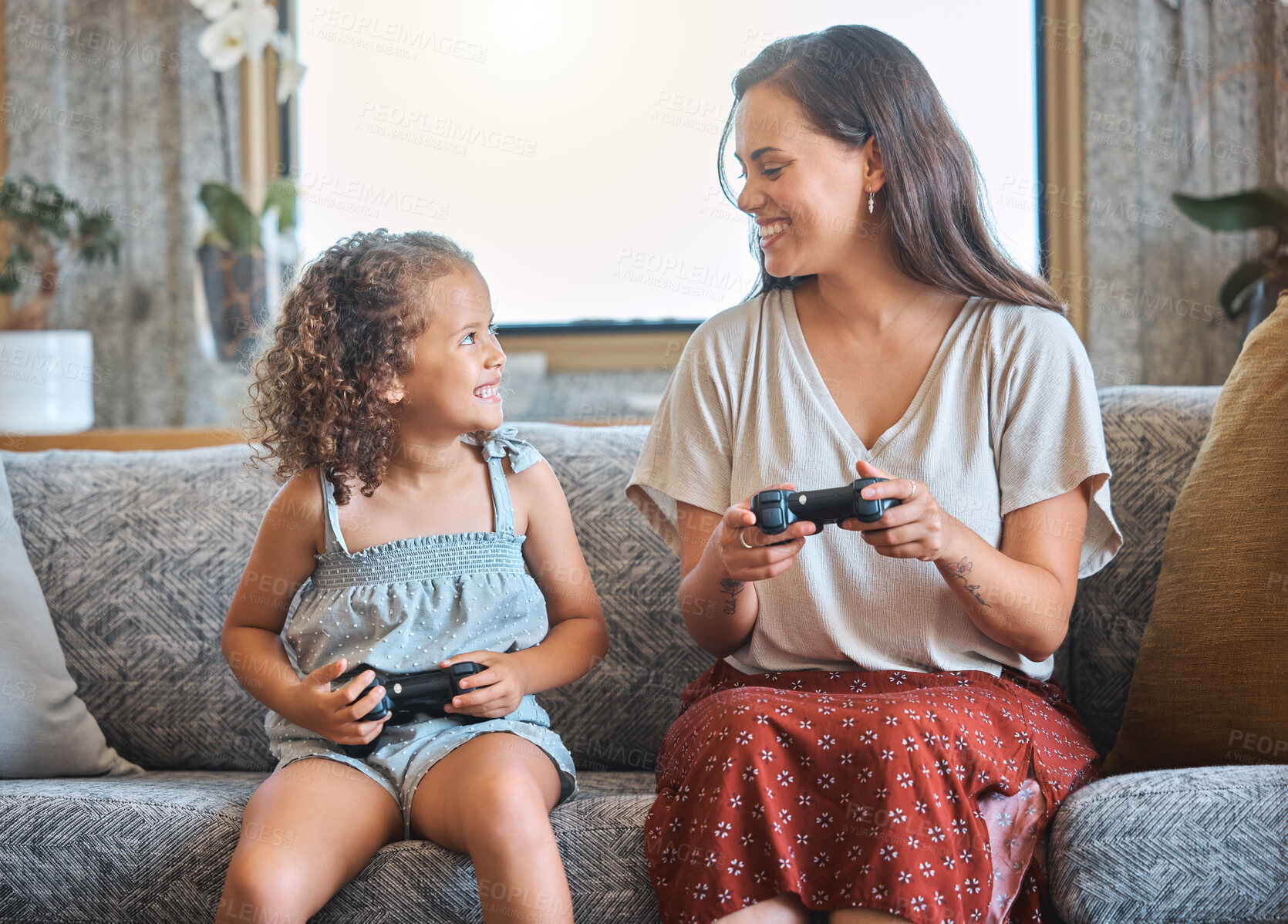 Buy stock photo Mother, girl and joystick for games in home, family and online competition or match in living room. Mama, daughter and streaming challenge for entertainment, bonding and playing together in apartment