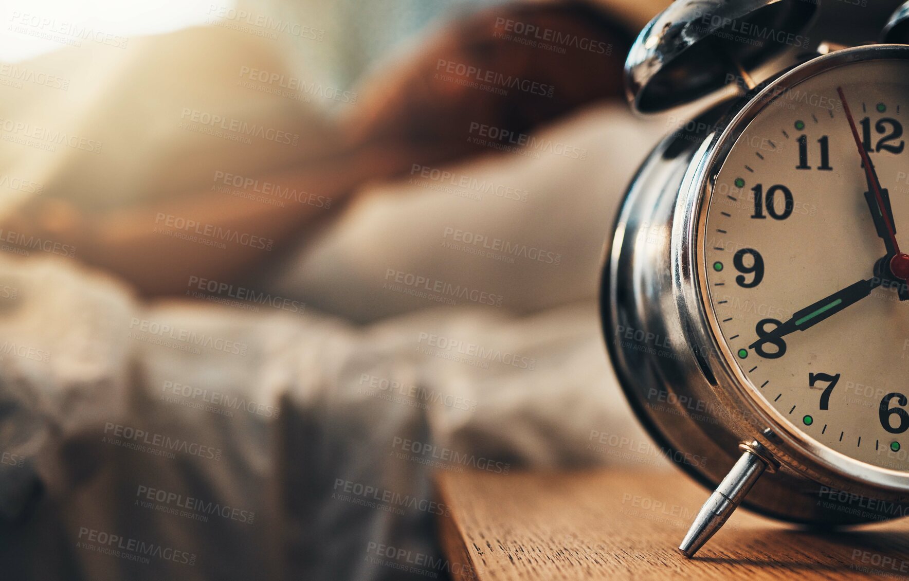 Buy stock photo Alarm clock, table and person sleeping, relax and resting in bedroom for energy or lazy at home. Time, bed and oversleeping with fatigue, morning and tired on comfortable mattress for peace or calm