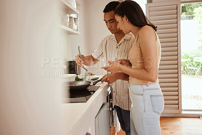 Buy stock photo Couple at home cooking food, learning a skill and tasting a recipe from pan in the kitchen together. girlfriend and boyfriend relaxed, prepare romantic meal, making dinner in pan with chef at home.