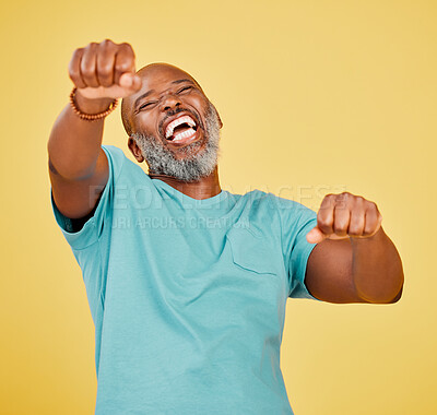 Buy stock photo Black man, studio and happy with fist pump for fashion with style, clothes and outfit on yellow background. Mature person, isolated and smile or excited for victory, winning and achievements