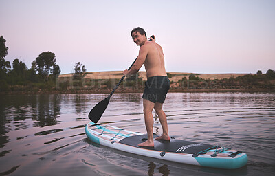 Buy stock photo Man, portrait and paddle board in lake for travel with adventure, summer vacation and fitness. Holiday, balance and floating in river for wellness, workout and water exercise for hobby in countryside