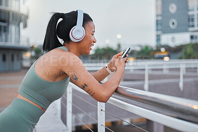 Buy stock photo Woman, happy and fitness in city with phone, music streaming and social media on break. Sports influencer, smile or mobile on Puerto Rico street for rest, progress app and follower interaction on run