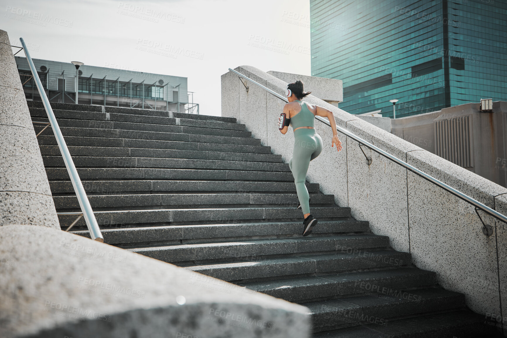 Buy stock photo Back, woman and running with headphones on steps for cardio training, listen to music and marathon practice. Athlete, girl and fitness exercise with endurance, sports workout and race performance