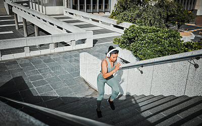 Buy stock photo Athlete, woman and running with headphones on stairs for cardio training, listen to music and marathon practice. Active, girl and fitness exercise with endurance, sports workout and race performance