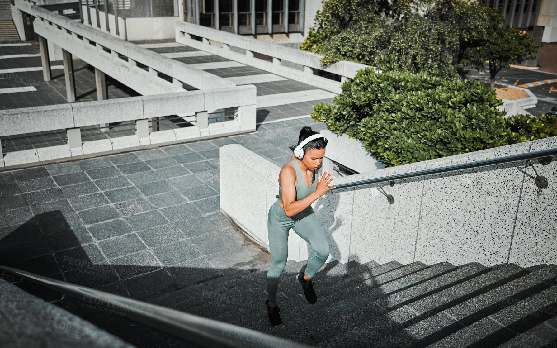 Buy stock photo Athlete, woman and running with headphones on stairs for cardio training, listen to music and marathon practice. Active, girl and fitness exercise with endurance, sports workout and race performance