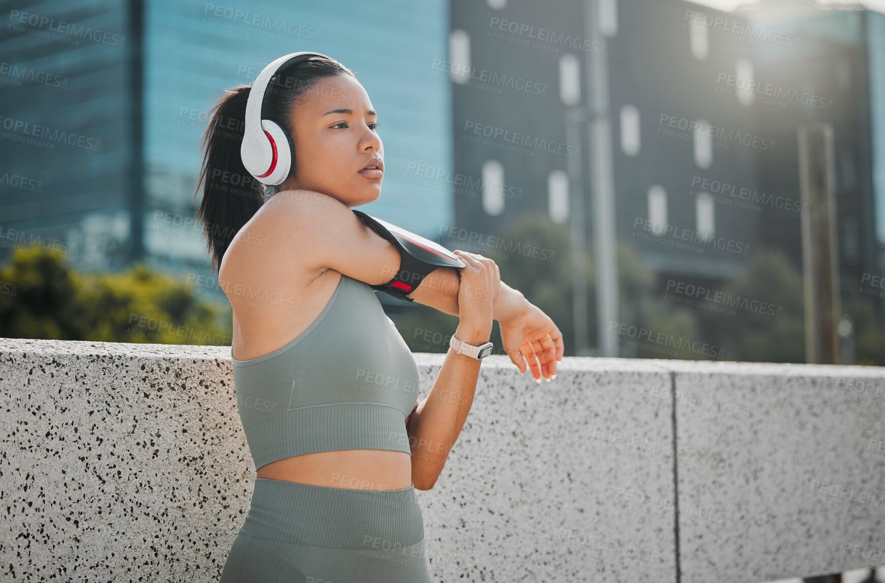 Buy stock photo Headphones, woman or runner stretching in city for fitness, marathon training or exercise health. Arm, music or girl athlete thinking in warm up for workout performance, outdoor jog or running ideas