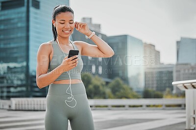 Buy stock photo Woman, fitness and mobile outdoor for music, exercise and health with earphones, smile and workout. Athlete, phone and streaming app in city for training, sports and radio with healthy cardio run