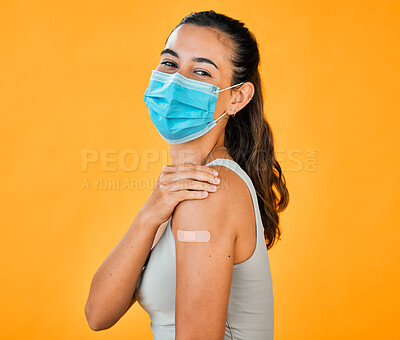 Buy stock photo Woman, covid and bandage with face mask for vaccination, safety and immunization for health. Portrait, model and compliance for pandemic, prevention and protection on yellow background in studio 