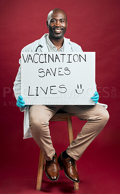 Buy stock photo Portrait, doctor and vaccine with poster in studio for covid19 message, healthcare choice and medical cure. Smile, black man and billboard with treatment advice, virus attention and red background