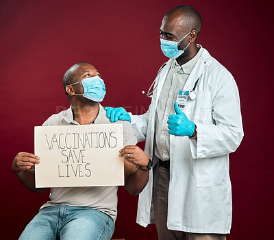 Buy stock photo Approval, thumbs up and African doctor with black man, vaccine or poster for pandemic safety. Patient, face mask and protection for corona, risk control or disease treatment on red studio background