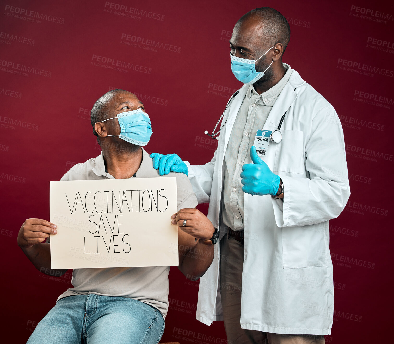 Buy stock photo Approval, thumbs up and African doctor with black man, vaccine or poster for pandemic safety. Patient, face mask and protection for corona, risk control or disease treatment on red studio background