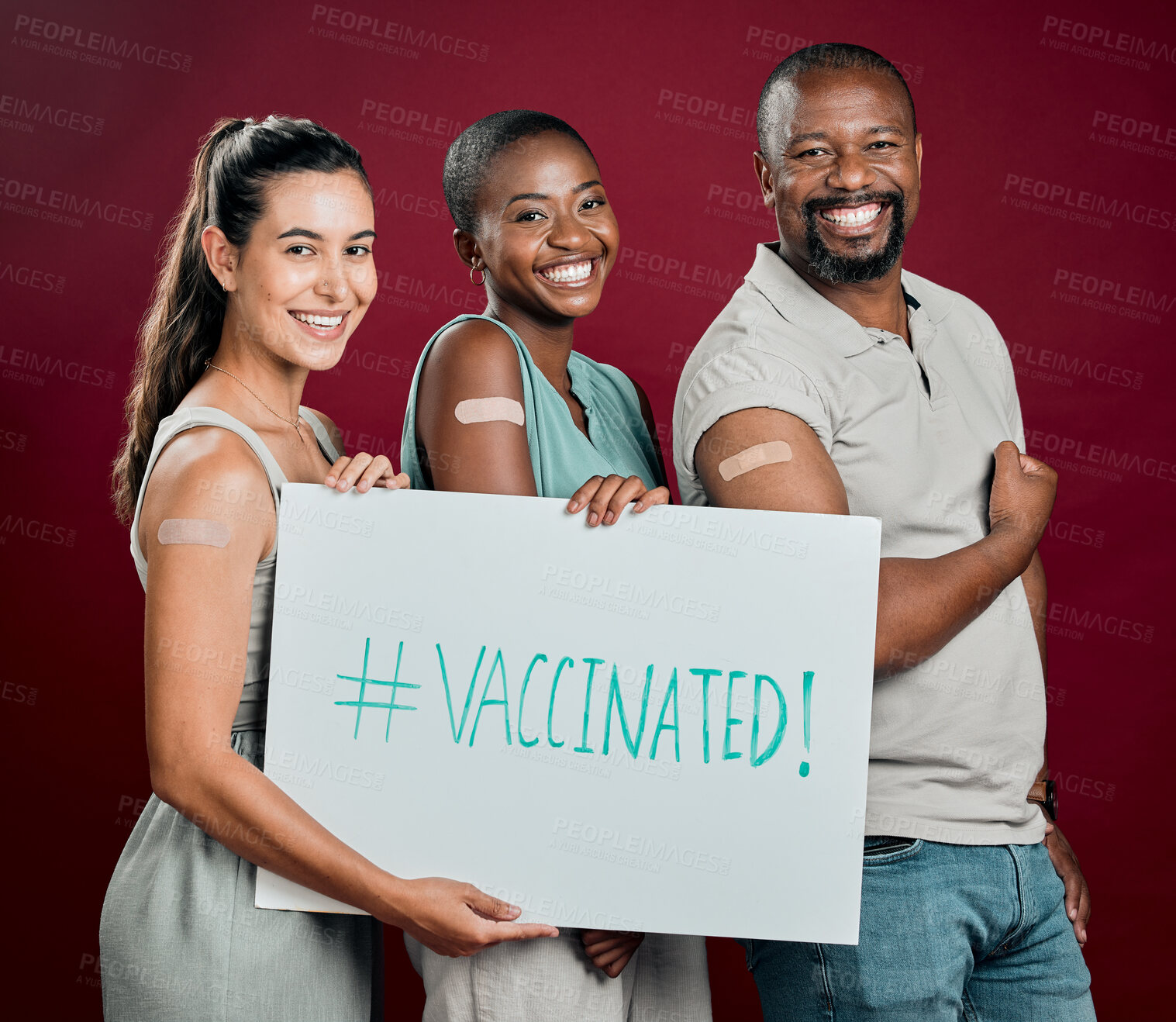 Buy stock photo Plaster, poster and vaccine with portrait of people in studio on red background for healthcare or medical. Hashtag, social media and smile of patient group holding sign for covid cure or prevention