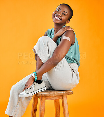 Buy stock photo Black woman, portrait and smile in studio background with plaster for vaccination and protection in Kenya. People, happy and healthcare or covid with bandage for virus immunity and prevention