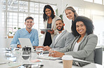 Diverse group of businesspeople having a meeting together at a table at work. Business professionals talking and planning while using technology in an office. Colleagues working together