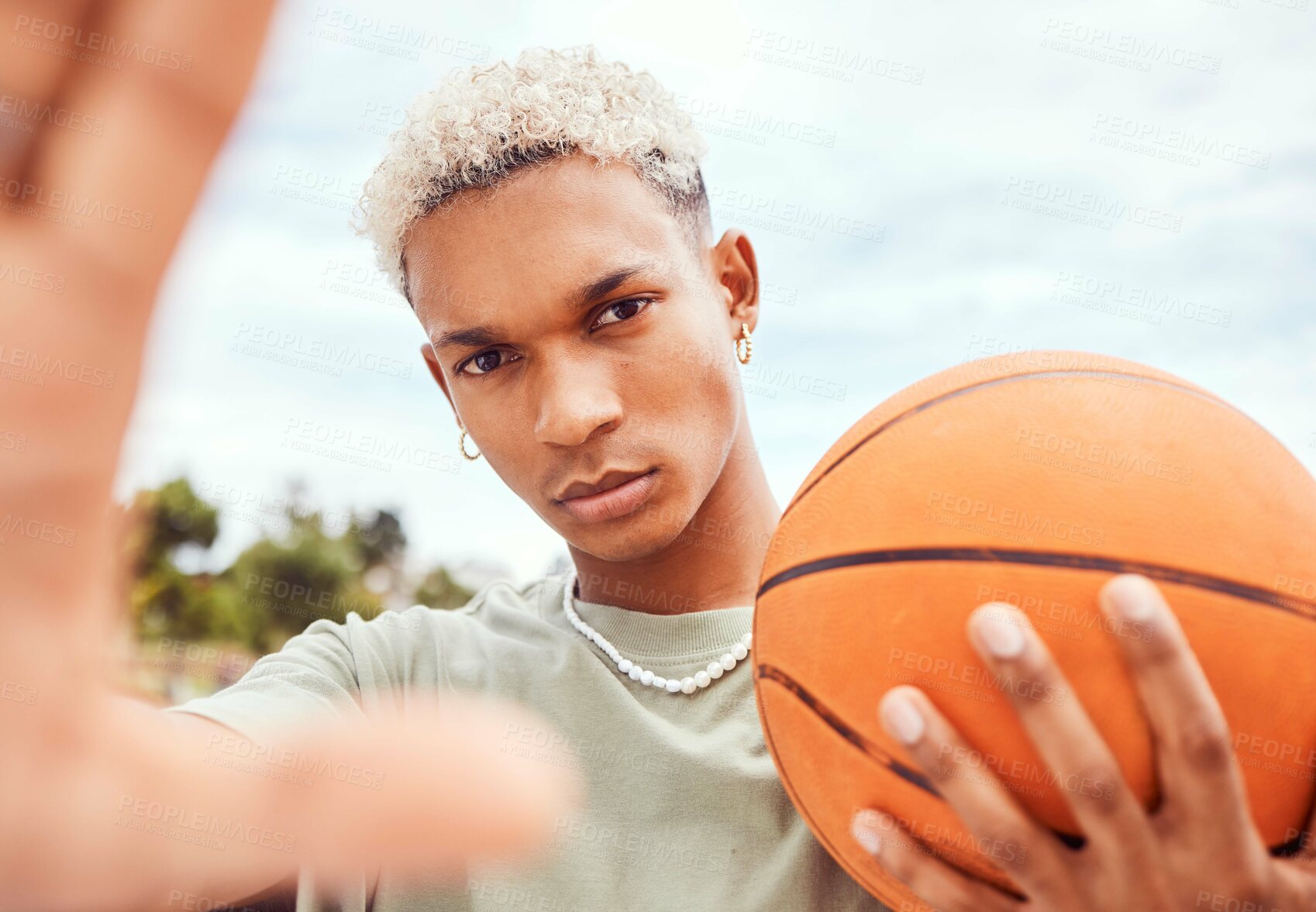 Buy stock photo Sports, selfie and basketball player with fashion with a ball standing on an outdoor court. Fitness, edgy and cool man model and athlete from Brazil posing for a picture with a casual outfit in city 