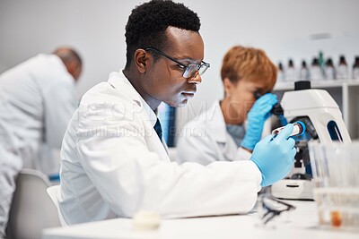 Buy stock photo Science, vial and black man with focus, laboratory and innovation for healthcare, wellness and vaccine. Research, Nigerian male employee and researcher with test tube, experiment or medicine for cure