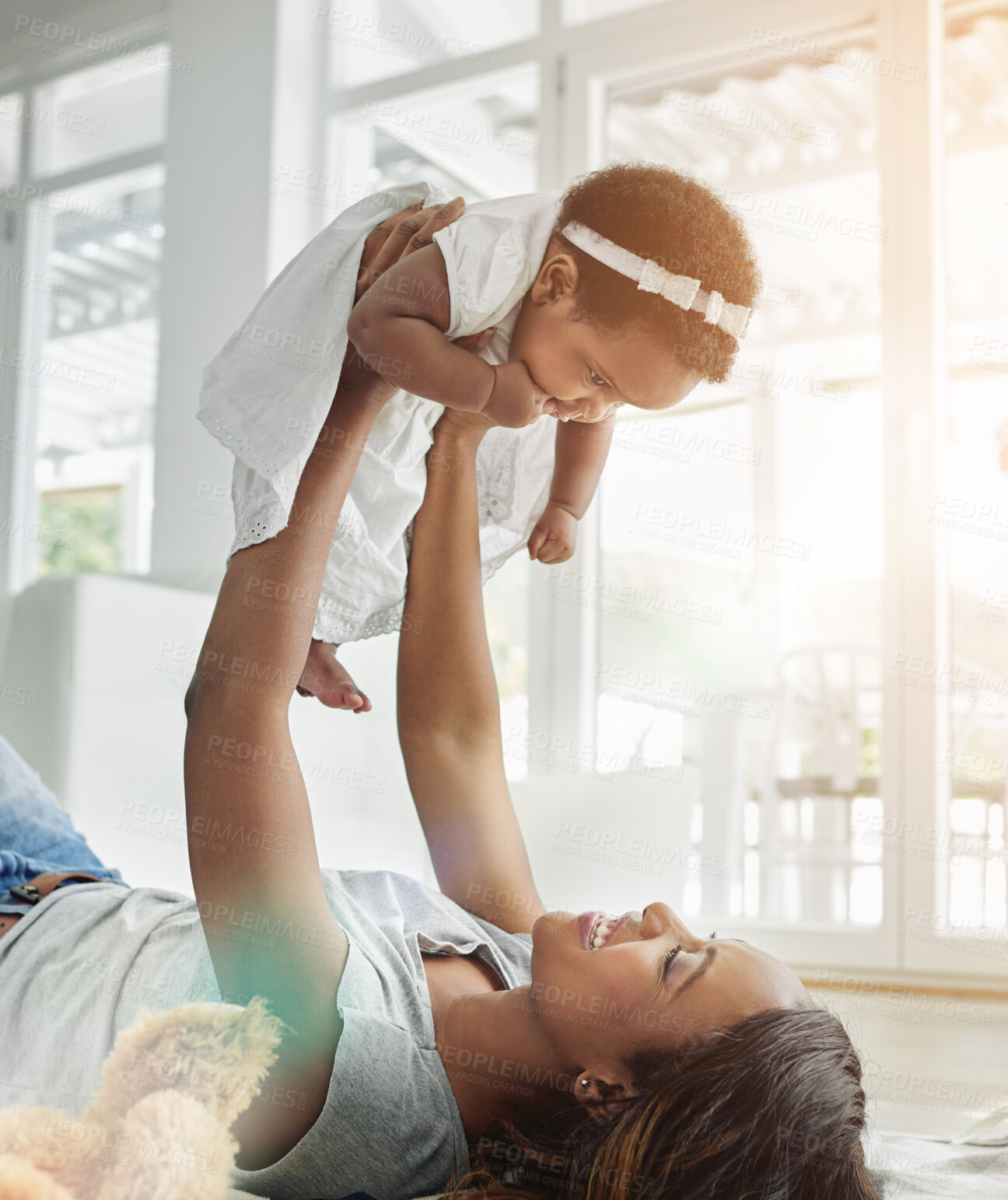 Buy stock photo Mother, baby and lift in home with trust, support and bonding play with flying fantasy. Black family, woman and toddler in living room for airplane game, child development and relationship growth