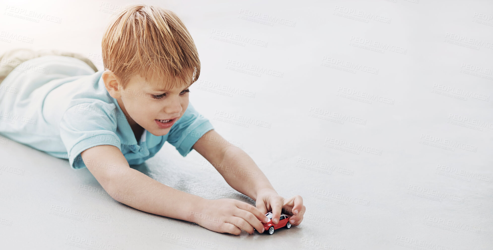 Buy stock photo Child, play and fun with toy car in studio of fantasy racing game, fine motor skills and hand and eye coordination. Kid, boy and vehicle learning, transport knowledge and activity on white background