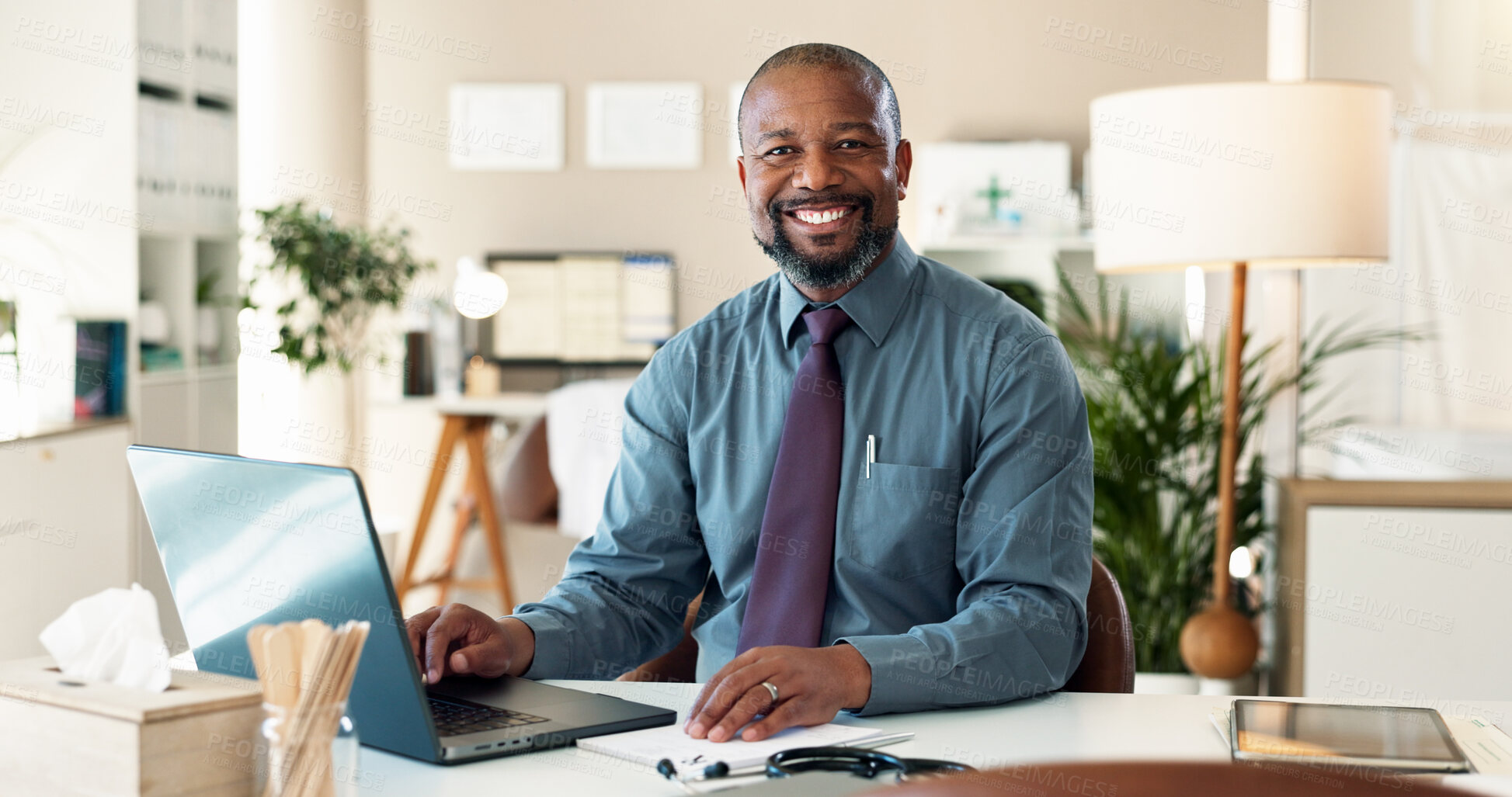 Buy stock photo Black man, doctor and portrait in office with laptop, desk and email for web consultation. Hospital, wellness and healthcare professional with confidence and online medical support or help on tech