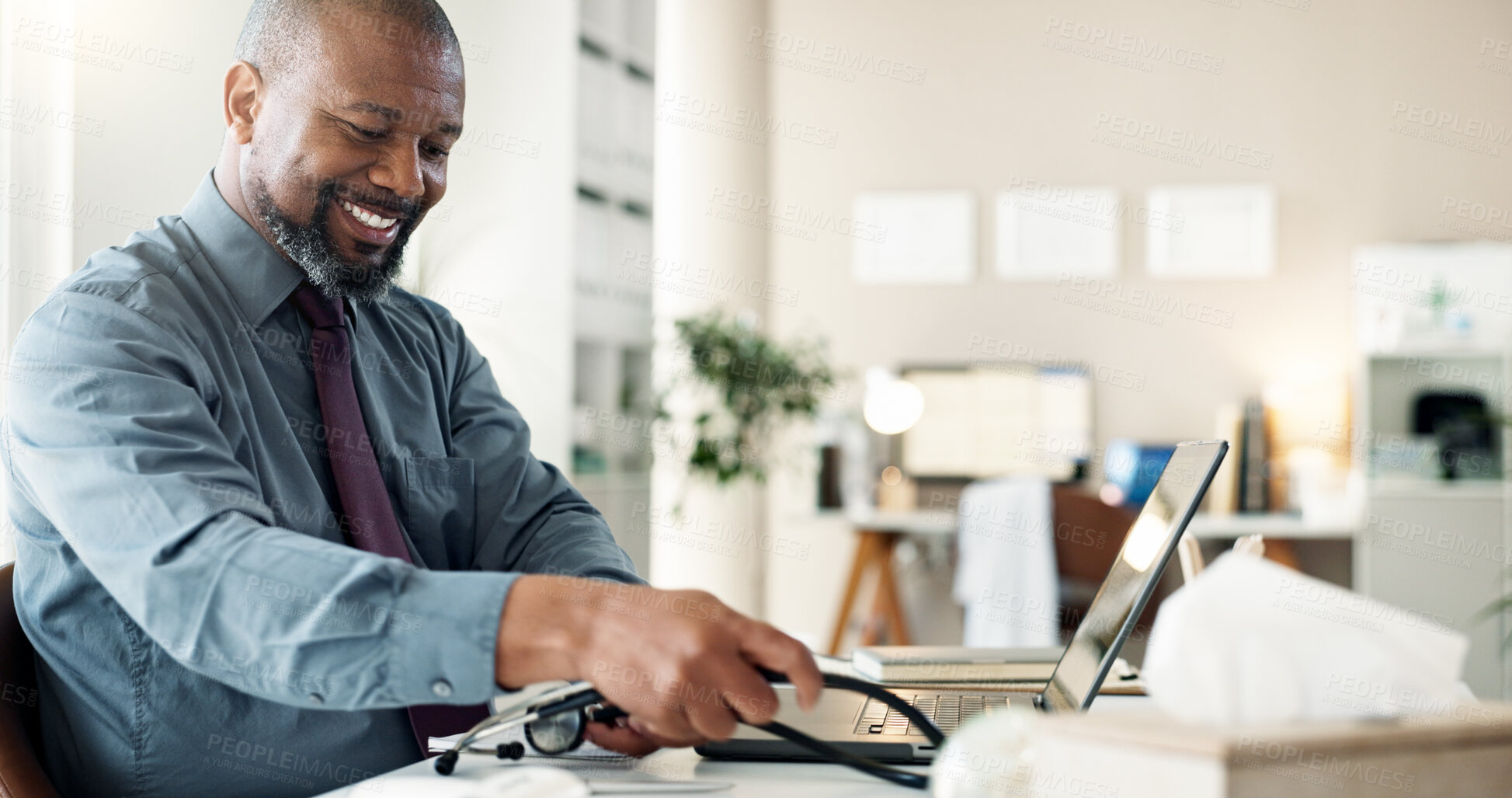 Buy stock photo Happy, doctor and man with laptop, smile and review of health records, wellness and office in hospital. Healthcare, working and black person with app for info, professional and analysis in clinic