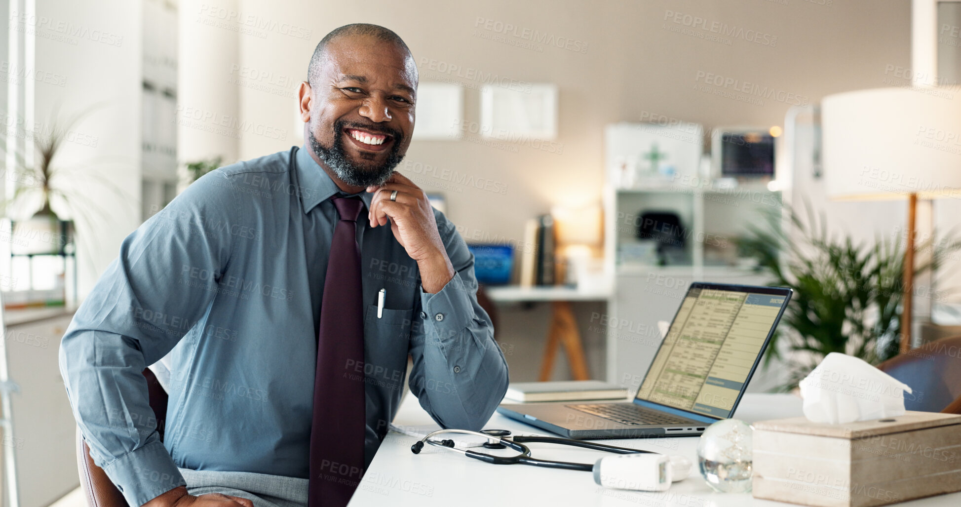 Buy stock photo Black man, doctor and portrait in office with smile, desk and tech for digital consultation. Professional, wellness and healthcare employee with confidence and website for online medical support