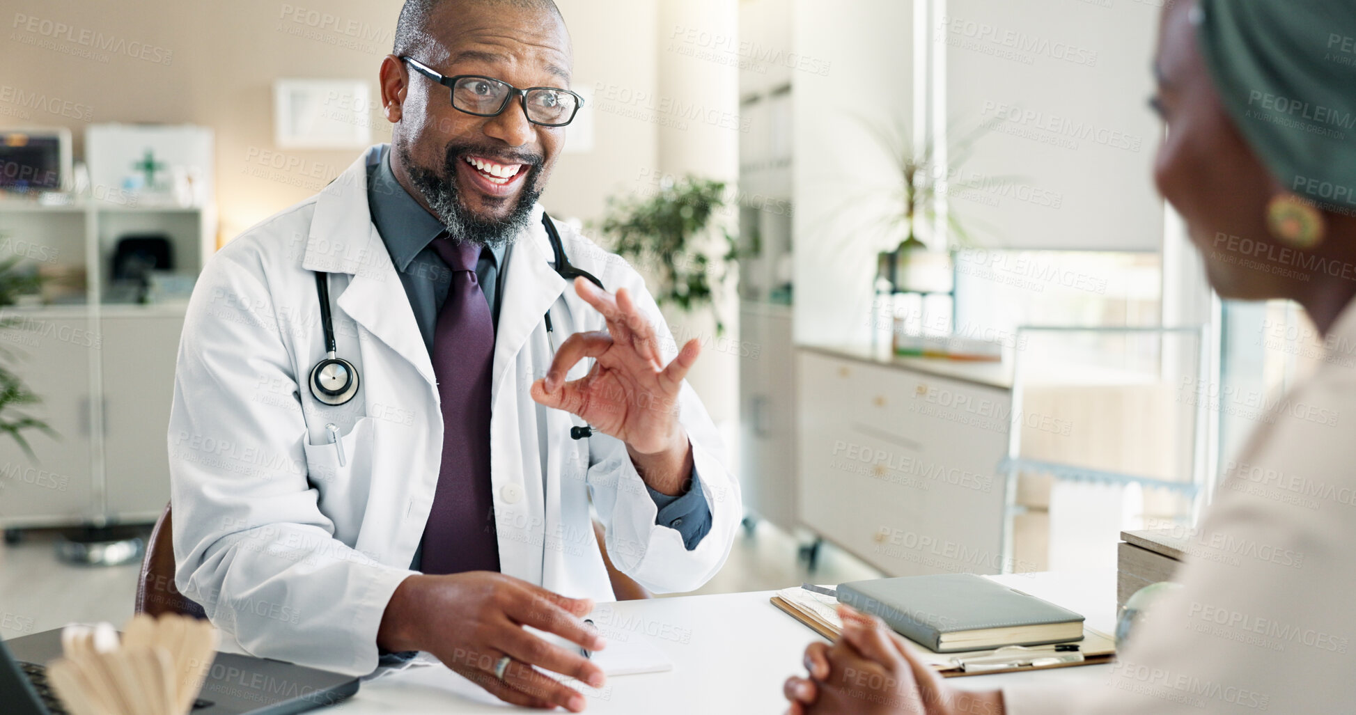 Buy stock photo Healthcare, okay or results with doctor and patient in office at hospital for consulting or positive feedback. Hand gesture, smile and medical professional man talking to person in clinic for checkup