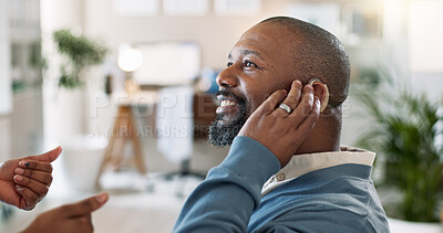 Buy stock photo Black man, smile and hearing aid in hospital for healthcare, help and doctor with thumbs up for approval. Mature person with disability, cochlea implant and ENT specialist in clinic for consultation