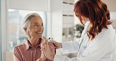 Buy stock photo Senior, woman and holding hands with doctor in consultation for medical results, support and empathy. Healthcare, professional and happy patient in clinic with compassion for test news and diagnosis