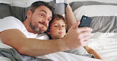 Buy stock photo Bed, father and funny face with boy on selfie for memories, social media and profile picture at home. Apartment, people and happy parent with kid as family for love, support and bonding in bedroom