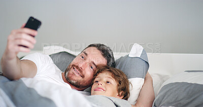 Buy stock photo Father, child and selfie on bed at house for photography morning, social media post and bonding together. Smile. man and boy relaxing for profile picture, family memory and relationship with support