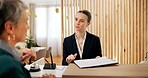 People. client and receptionist in hotel with clipboard, booking information and checklist on counter. Help desk, hospitality and concierge with mature customer for service, assistance or reservation