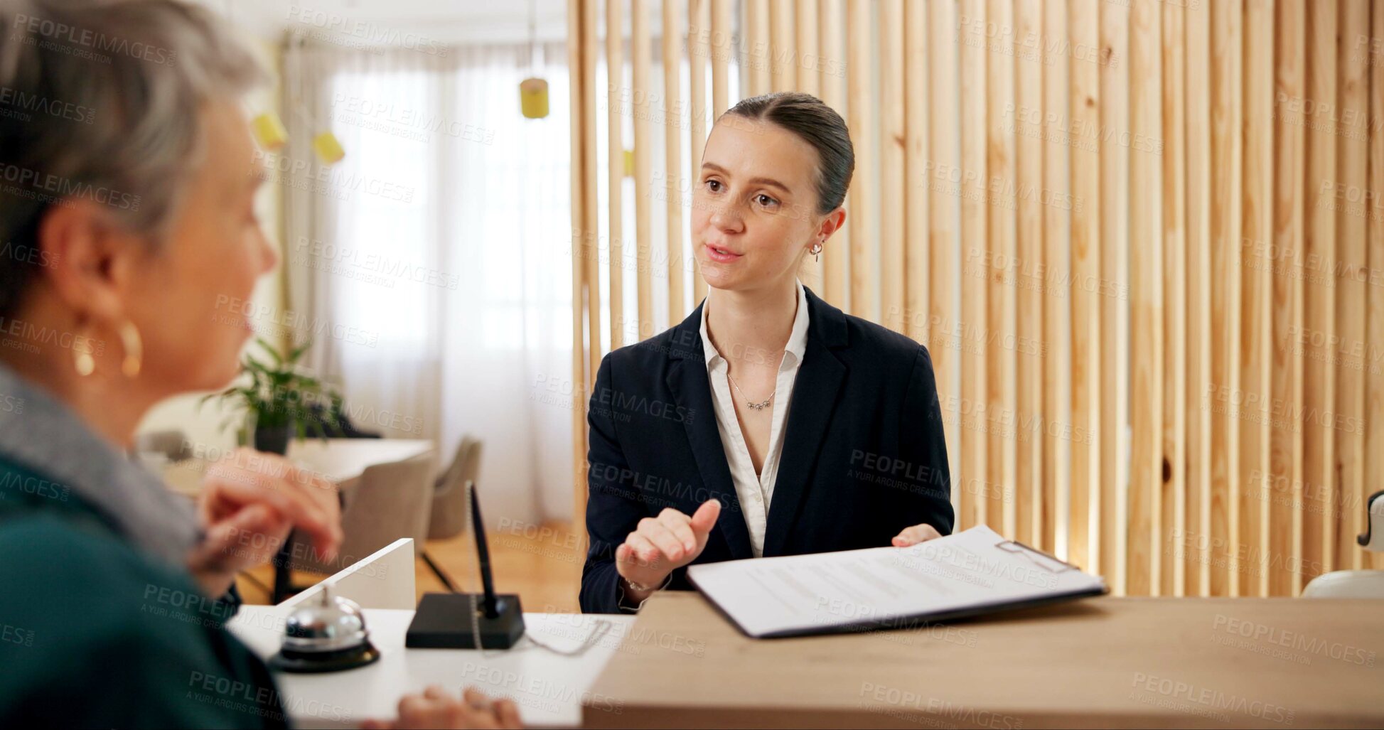 Buy stock photo People, client and receptionist in hotel with clipboard, booking information and checklist on counter. Help desk, hospitality and concierge with mature customer for service, assistance or reservation