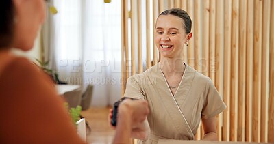 Buy stock photo Spa, woman and client at reception for payment with smile, online banking and luxury service at hotel. Credit card, girl and receptionist at desk with pos, hospitality and check in at beauty salon.