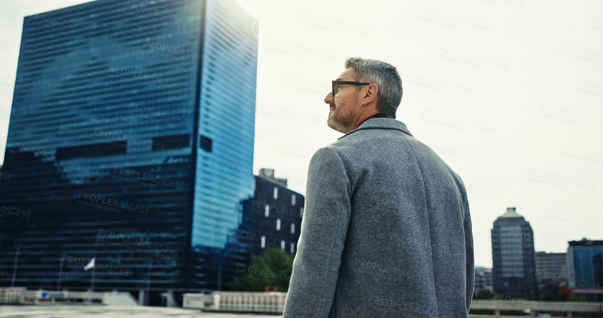 Buy stock photo Business man, walking and traveling in city for journey, work and start of day in morning with back. Realtor, career and commute in urban town with buildings, real estate agent and professional trip
