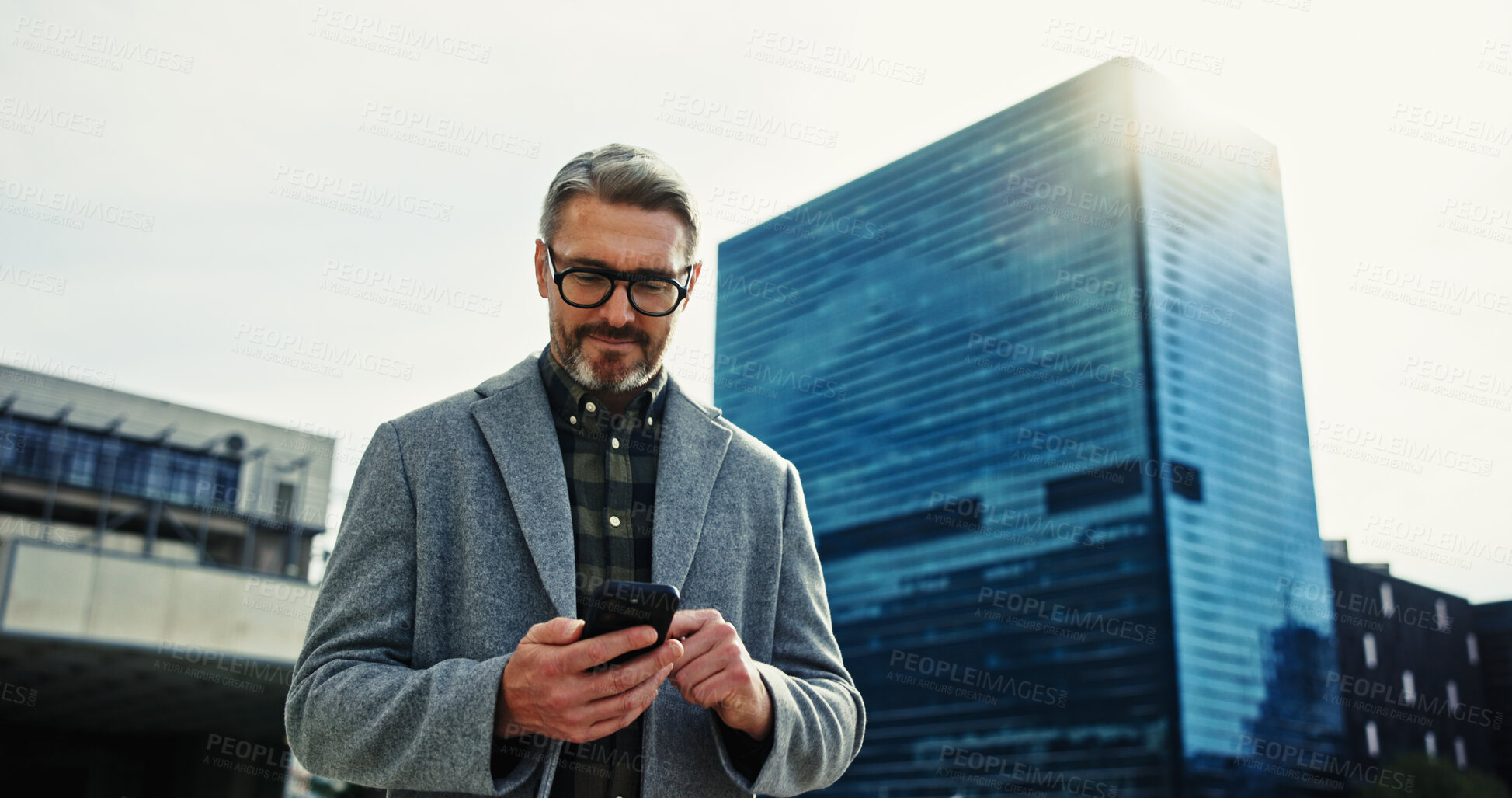 Buy stock photo Building, commute and phone with mature businessman outdoor in city for communication, networking or travel. App, contact and directions with corporate employee in urban town to search for location 