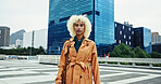 City, fashion designer and woman with portrait or confidence in trendy coat in New York alone. Outdoor, serious or creative female person in urban town for travel, commute or sightseeing on holiday