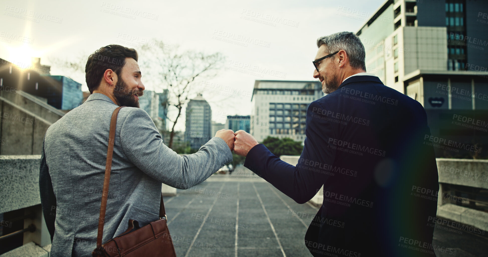 Buy stock photo Outdoor, fist pump and commuting to work, men and smile for motivation, accountant and colleagues. Happy, greeting and business people in city, success and friends with camaraderie and celebration