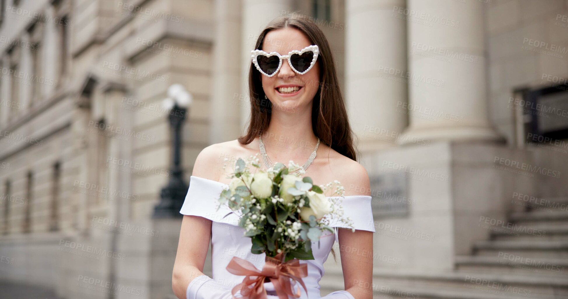Buy stock photo Woman, bride and bouquet with sunglasses in city by court, excited or smile with heart shape for marriage. Person, wedding dress and flowers for celebration, lens or love emoji for milestone in Spain